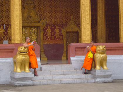 Orange wrapped Buddhist monks are very much part of Luang Prabang's scenery.  This World Heritage town boasts over 60 temples and these novices and monks study and live in many of them.