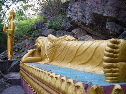 On the slopes of the 100m high Phu Si hill you pass many new Buddhist statues amid the ruins of an abandoned temple.