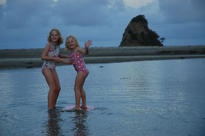 The girls enjoying our last beach stop in New Zealand at Waiwera - just 30 minutes north of Auckland.  They look so grown up!<br />
Photo by Greg Peacocke