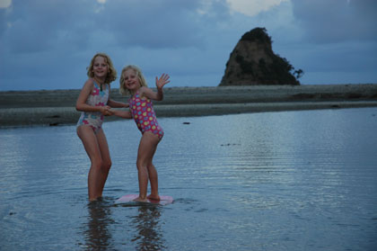 The girls enjoying our last beach stop in New Zealand at Waiwera - just 30 minutes north of Auckland.  They look so grown up!<br />
Photo by Greg Peacocke