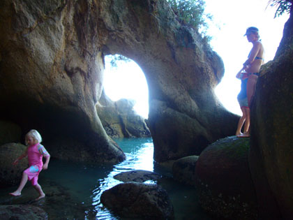 Exploring some caves during our stop at a secluded beach in the Abel Tasman National Park.  South Island.  NZ.